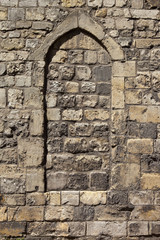 Architectural background with a stone arch set in the medieval walls of the historic city of York