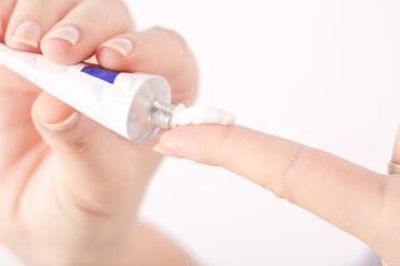 Close up image of hands with cream tube