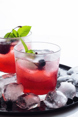 Red drink with basil and berries. © ytochka89
