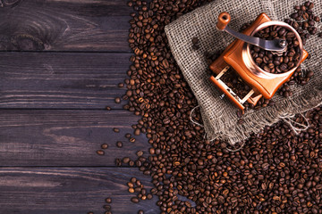 Coffee mill on dark wooden background, top view with copy space