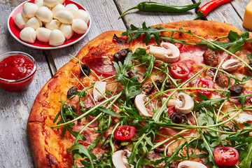 Pizza with prosciutto and arugula.