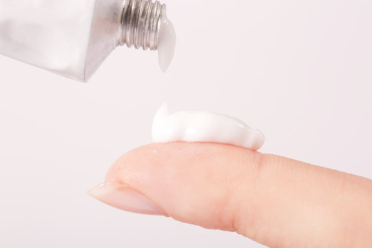 Close up image of hands with cream tube