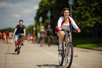 Urban bicycle - teenage girl and boy cycling 