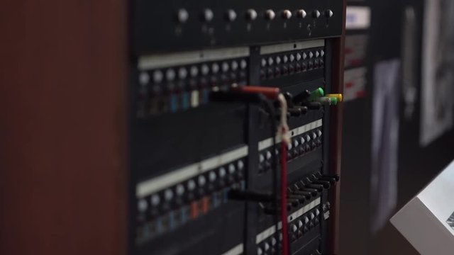Close-up of female hand using 30-line teleprinter switchboard. Old network service