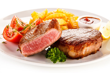 Grilled beefsteak with french fries on white background 