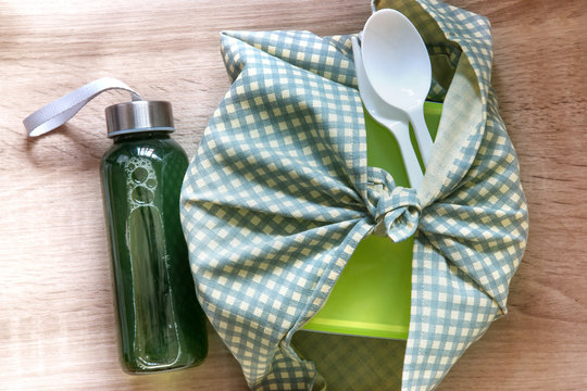 The Healthy Lunch Box Wrapped  By Japanese Wrapping Cloth Furoshiki Style With Green Vegetables And Fruits Juice Bottle , Homemade  Healthy  Lunch Box Set For Diet And Healthcare Concept