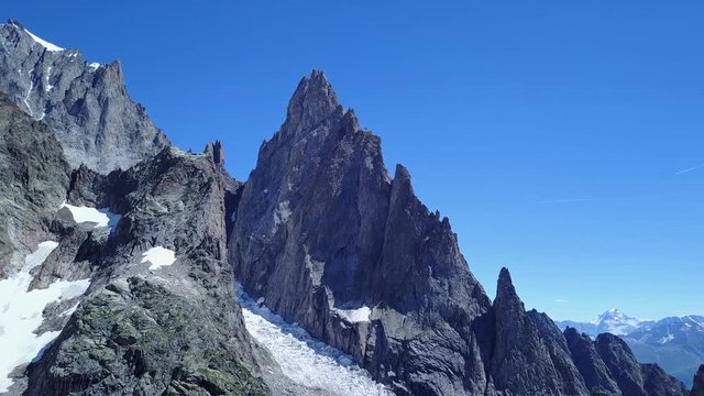 Aerial view of peaks in an alpine valley. AIGUILLE NOIRE (Mont Blanc / Monte Bianco massif), Val Veny, Courmayeur, Val d'Aosta, Italy.