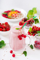 Yoghurt-strawberry smoothies in a jar on a white background