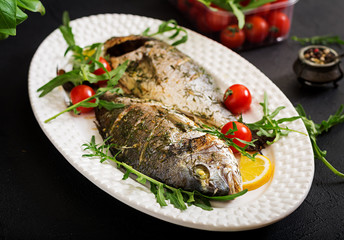 Baked dorado fish  in garlic dill sauce  and lemon.Flat lay.Top view