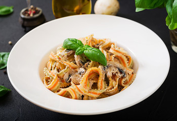 Colorful Pasta pappardelle with mushrooms in cream sauce.