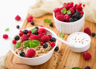 Tasty and healthy oatmeal porridge with berry, flax seeds and yogurt. Healthy breakfast. Fitness food. Proper nutrition