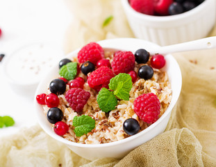 Tasty and healthy oatmeal porridge with berry, flax seeds and yogurt. Healthy breakfast. Fitness food. Proper nutrition
