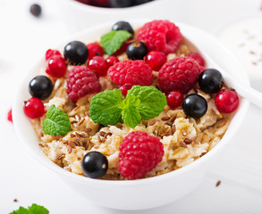 Tasty and healthy oatmeal porridge with berry, flax seeds and yogurt. Healthy breakfast. Fitness food. Proper nutrition