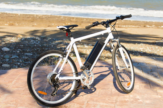 Bicycle parked in the beach sand.