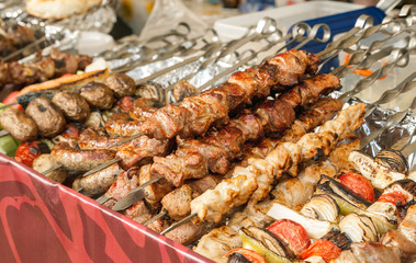 Variety of cooked kebab meat on a metal skewers