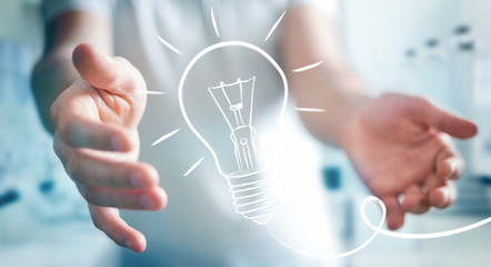 Businessman holding a sketch lightbulb