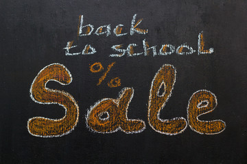 "back to school sale" inscription in chalk on a black chalk board