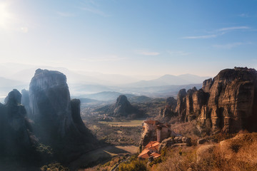 Greece, Meteora - incredible sandstone rock formations. The Holly Monastery of Rousanou and St. Nikolaos Anapafsas Monastery on sunset