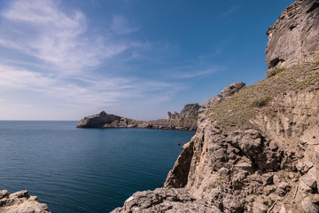 Kind on the cape of Kapchik and Blue bay. Amazing view on black sea near rocks in hot summer. Vacation, summer travel. Rocks in the Black Sea. Crimea