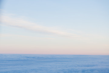 Obraz premium flying above the clouds at sunset landscape from an airplane