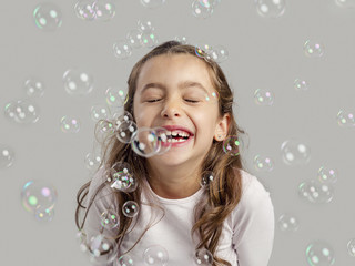 Girl playing with soap bubbles