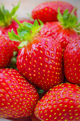 Background with berries of strawberry macro. The texture of a juicy fresh bright tasty strawberry close-up.