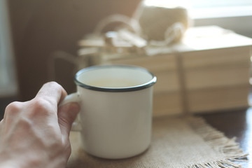 White iron mug on the windowsill
