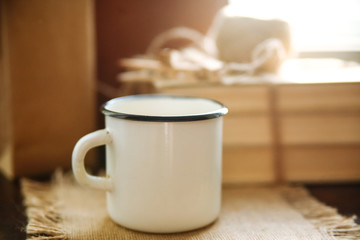 White iron mug on the windowsill