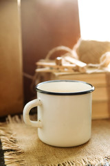 White iron mug on the windowsill