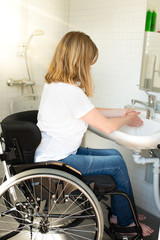 Person in a wheelchair washing hands