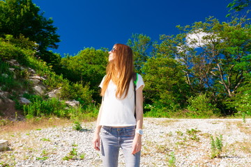 Mountain summer. Jeans, white t-shirt, sunglasses