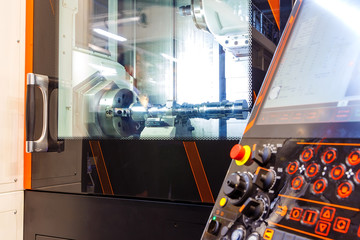 Metalworking CNC milling machine. Cutting metal modern processing technology. Small depth of field. Warning - authentic shooting in challenging conditions.