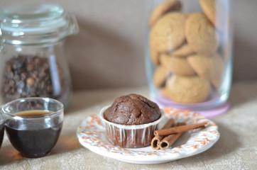 Two cups of coffee on the table. A table with breakfast. plate with muffin, on a background of a jar of coffee beans