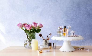 Stand with bottles of perfume on table