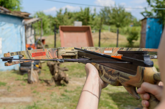 Man aims at target by crossbow or arbalest.