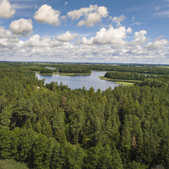 Aerial view of green islands and clouds at summer sunny day.Wydminy lake on Masuria in Poland.