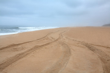 Fototapeta na wymiar Storm and deserted beach of the ocean in Portugal, Atlantic