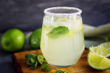 Delicious margarita cocktail on wooden board