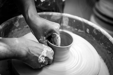 Hands working at the pottery  wheel