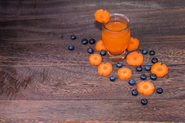Healthy eating and dieting concept,fresh carrot  and carrot juice or organic healthy juice in glass ,fruit,vegetables on a grey wooden table wall background