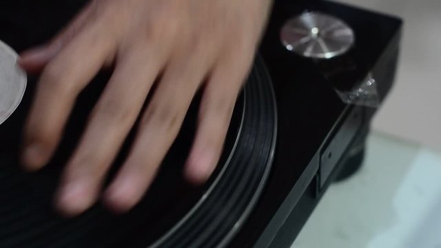 hand DJ scratching on the Turntables