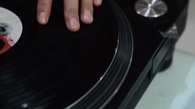 hand DJ scratching on the Turntables