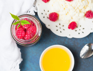 Homemade pancakes with honey, raspberries, cottage cheese with powder sugar. Flat lay, top view. copy space. eco style