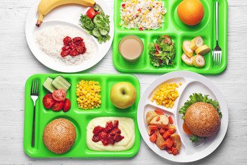 Serving trays with delicious food on table. Concept of school lunch