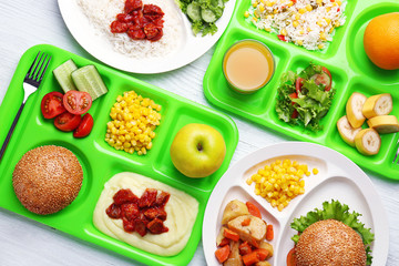 Serving trays with delicious food on table. Concept of school lunch