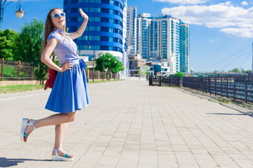 Woman in blue skirt and shirt, city, fun, full height