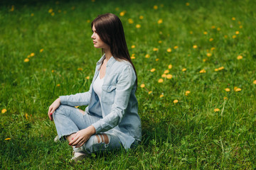 Young girl meditating in park