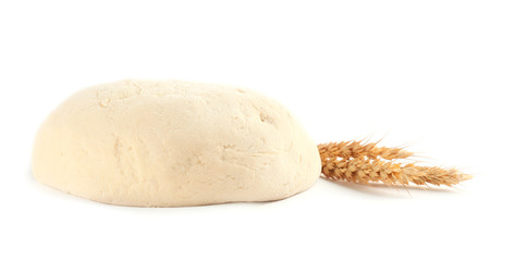 Fresh raw dough and wheat on white background