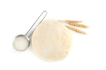 Fresh raw dough, sieve and wheat on white background