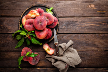 Peach, saturn or donut peaches with leaves